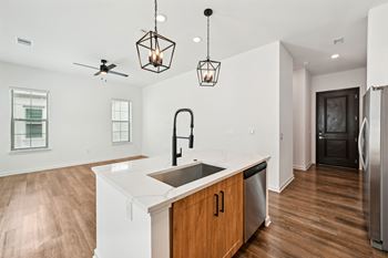 A kitchen with a white counter top and wooden cabinets at The Hadley - North Port, FL Apartments, Florida, 34287